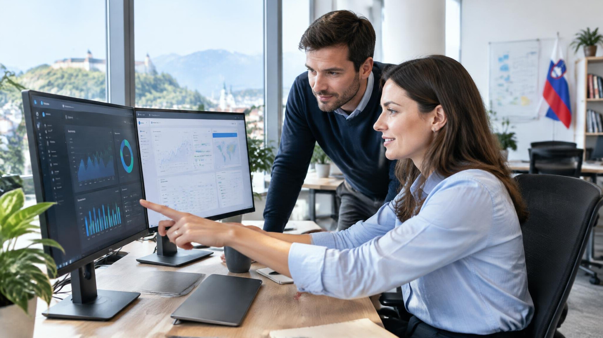 Team of software developers reviewing insurance platform code on large screens in a modern office