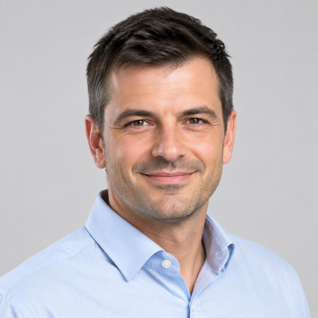 Studio portrait of a slovenian man in his 40s with short hair wearing a business shirt